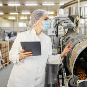 A food plant supervisor is evaluating quality of salty sticks on tablet.